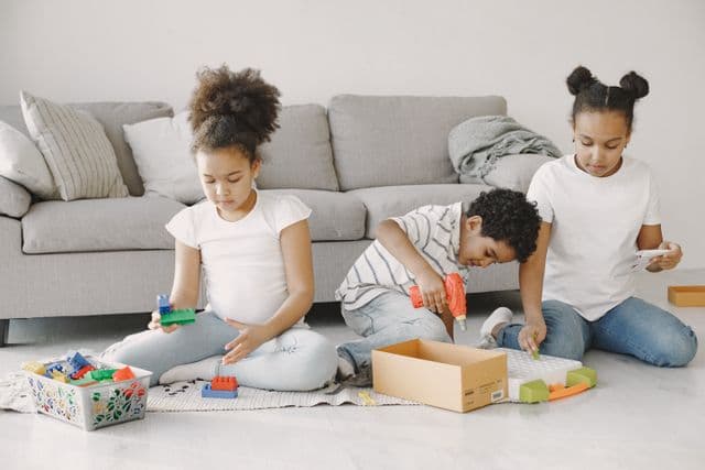 Three kids playing legos