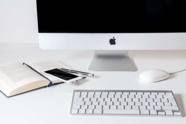 Apple desktop and iPhone on desk